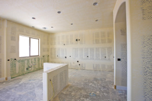 Empty new kitchen with fresh plasterboard